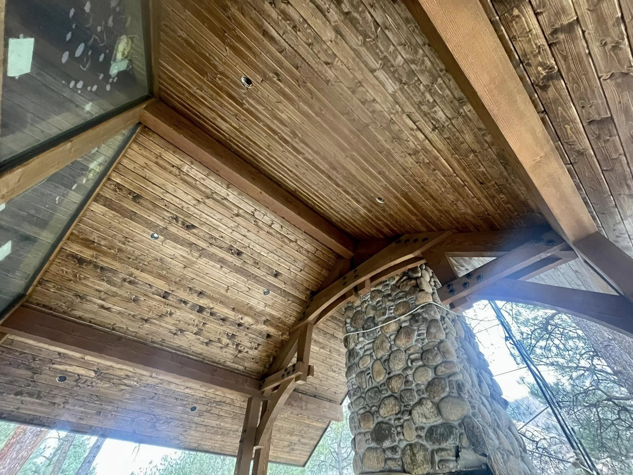 Heavy timber ceiling and river stone chimney detail